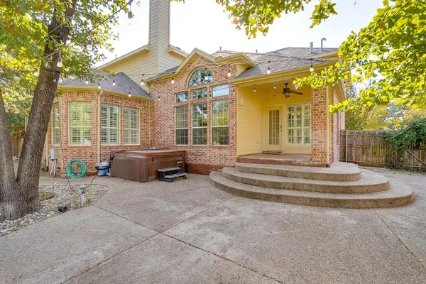 a view of a house with a backyard and a tree