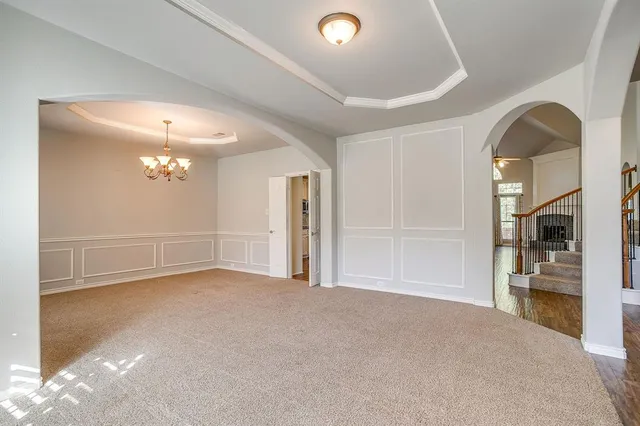 an empty room with closet and a chandelier fan