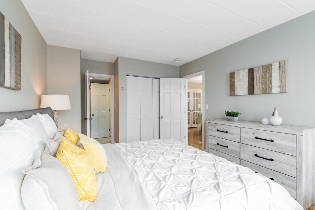 345 Harvard Street, Unit 3C Cambridge, MA 02138 - Photo 12 of 21 a bed room with a bed and a mirror