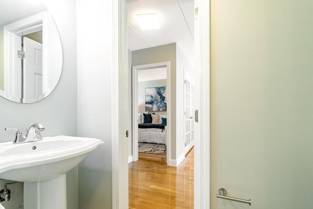 345 Harvard Street, Unit 3C Cambridge, MA 02138 - Photo 14 of 21 a en suite bathroom with a sink and a mirror