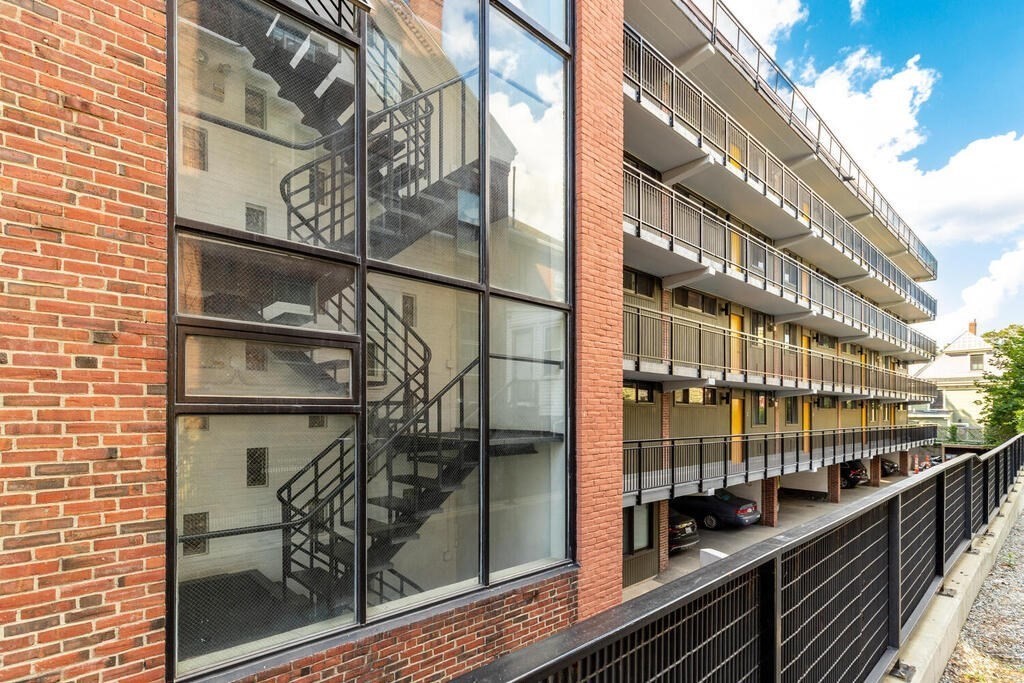 345 Harvard Street, Unit 3C Cambridge, MA 02138 - Photo 19 of 21 a view of a balcony with a potted plant on the side of a building