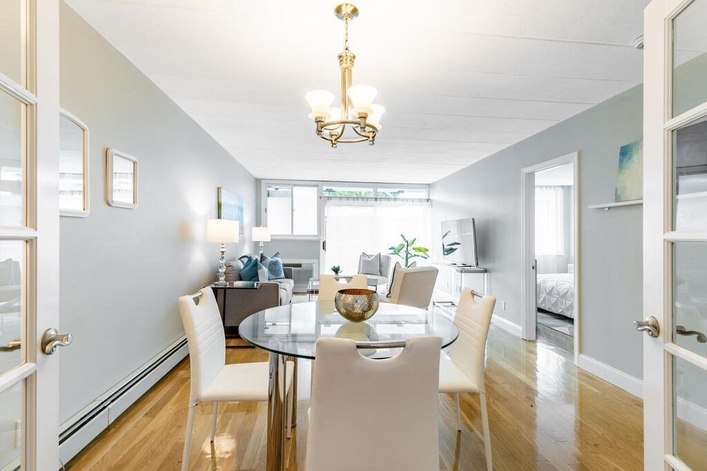 345 Harvard Street, Unit 3C Cambridge, MA 02138 - Photo 3 of 21 a view of a dining room with furniture and a chandelier