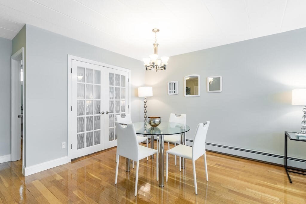 345 Harvard Street, Unit 3C Cambridge, MA 02138 - Photo 4 of 21 a view of a dining room with furniture and wooden floor