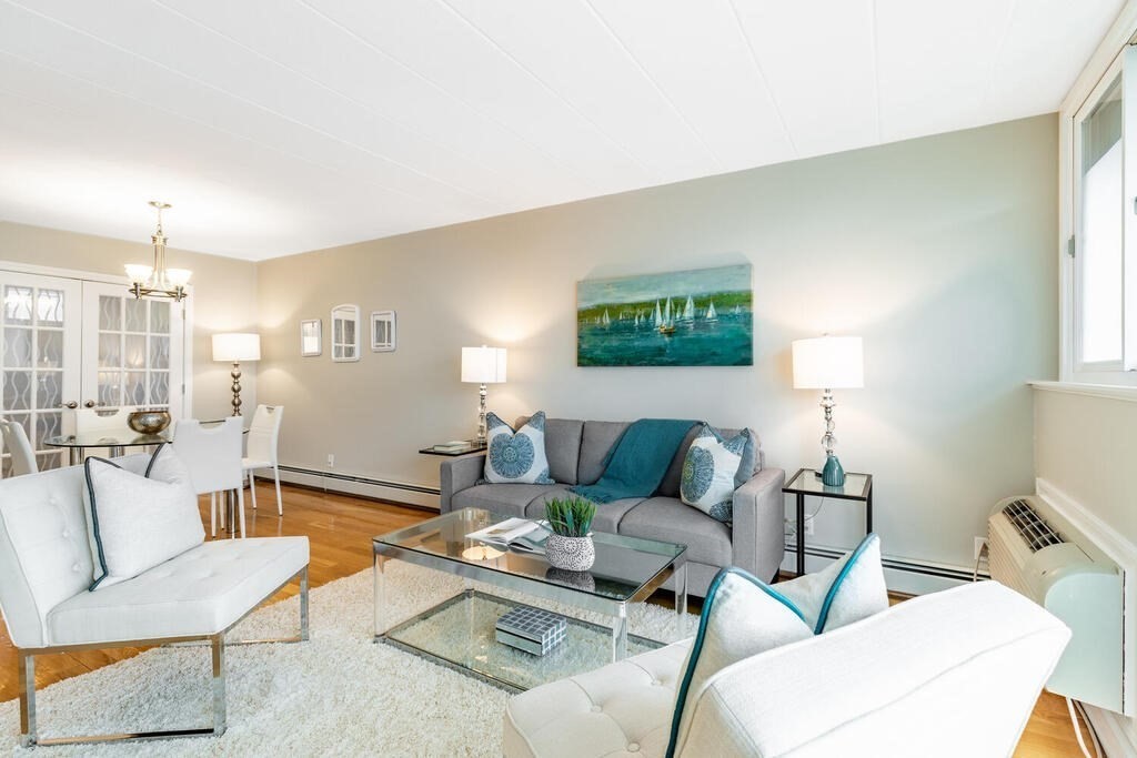 345 Harvard Street, Unit 3C Cambridge, MA 02138 - Photo 7 of 21 a living room with furniture and a lamp