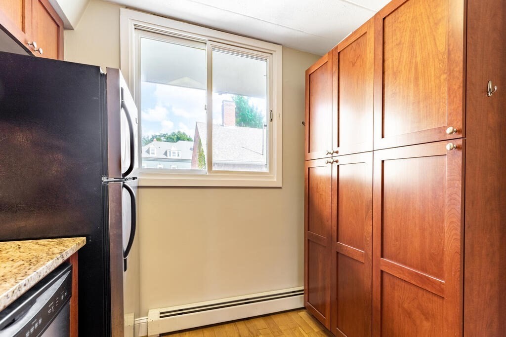 345 Harvard Street, Unit 3C Cambridge, MA 02138 - Photo 10 of 21 a view of a kitchen with a refrigerator and window
