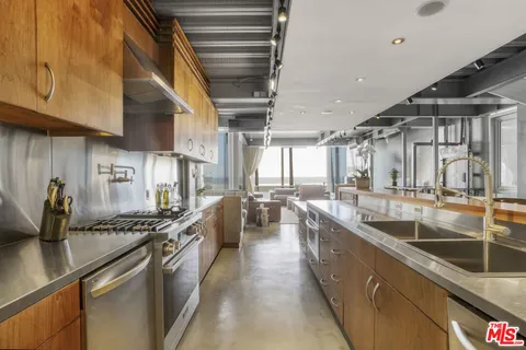 a view of a living room with kitchen and furniture