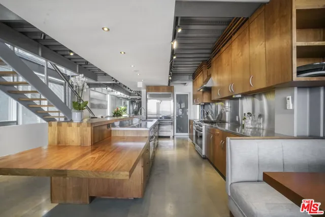 a view of a living room with a floor to ceiling window and wooden floor