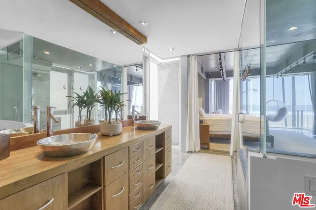 a bed sitting in a room next to a window