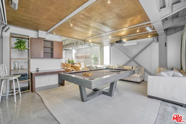 a bathroom with a granite countertop sink a toilet a mirror and shower