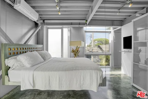 a view of staircase with wooden floor and white walls