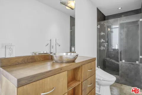 a bedroom with a bed and a night stand