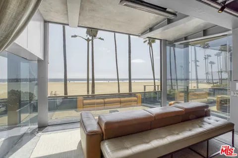 a view of a ocean with couches and city view