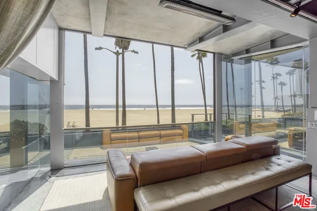 a view of a ocean with couches and city view