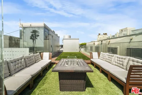 a view of living room kitchen with stainless steel appliances