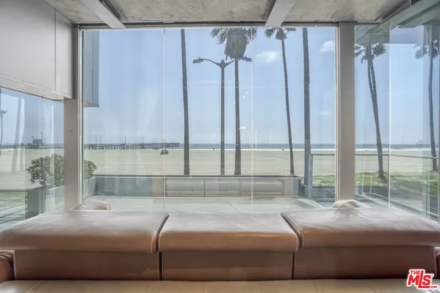 a living room with furniture a flat screen tv and a large window