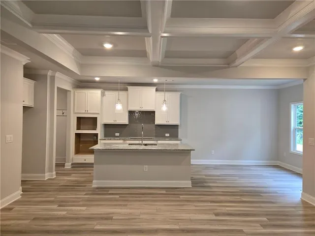 a view of kitchen with sink microwave and refrigerator