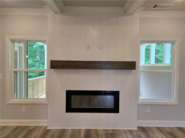 a living room with a fireplace and a window