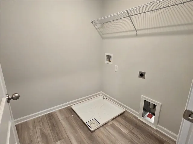 a view of a room with wooden floor and fan