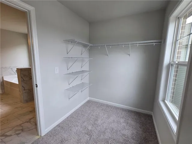 a view of a room with rack on the wall and a window
