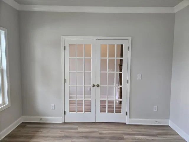 a view of empty room with wooden floor and cabinet
