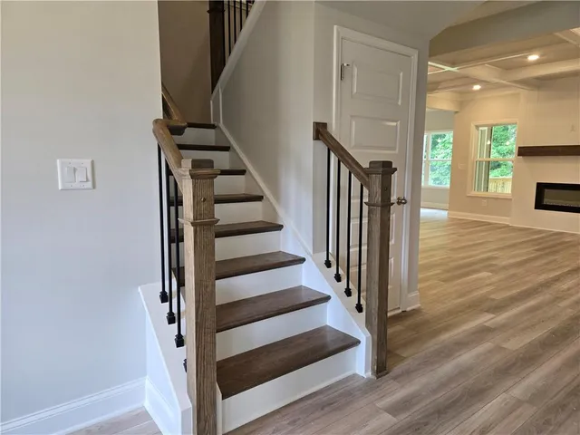 a view of entryway and hall with wooden floor