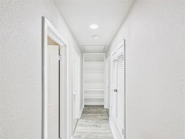 a view of a yard in front of a house with large trees