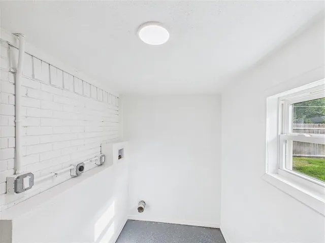 a bathroom with a bathtub and a window