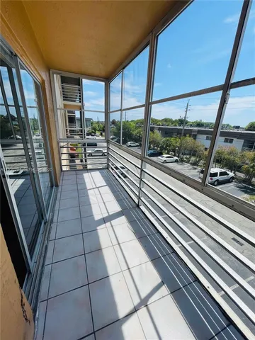 a view of a livingroom with a chandelier furniture and windows