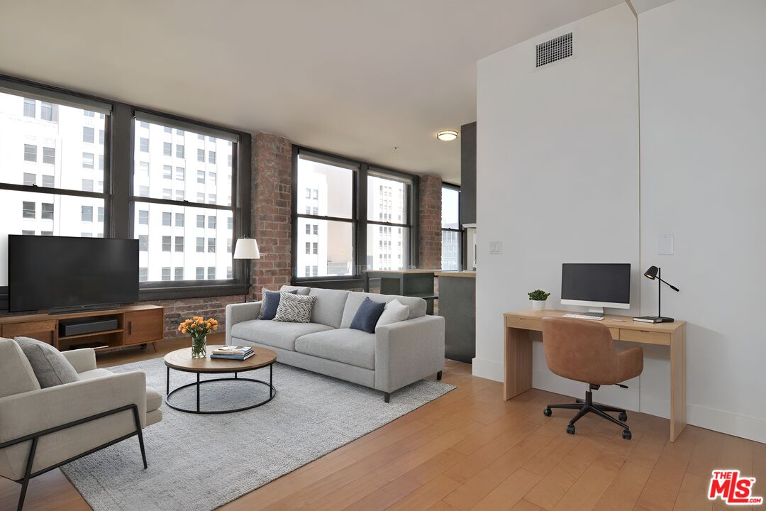 a living room with furniture tv and a window