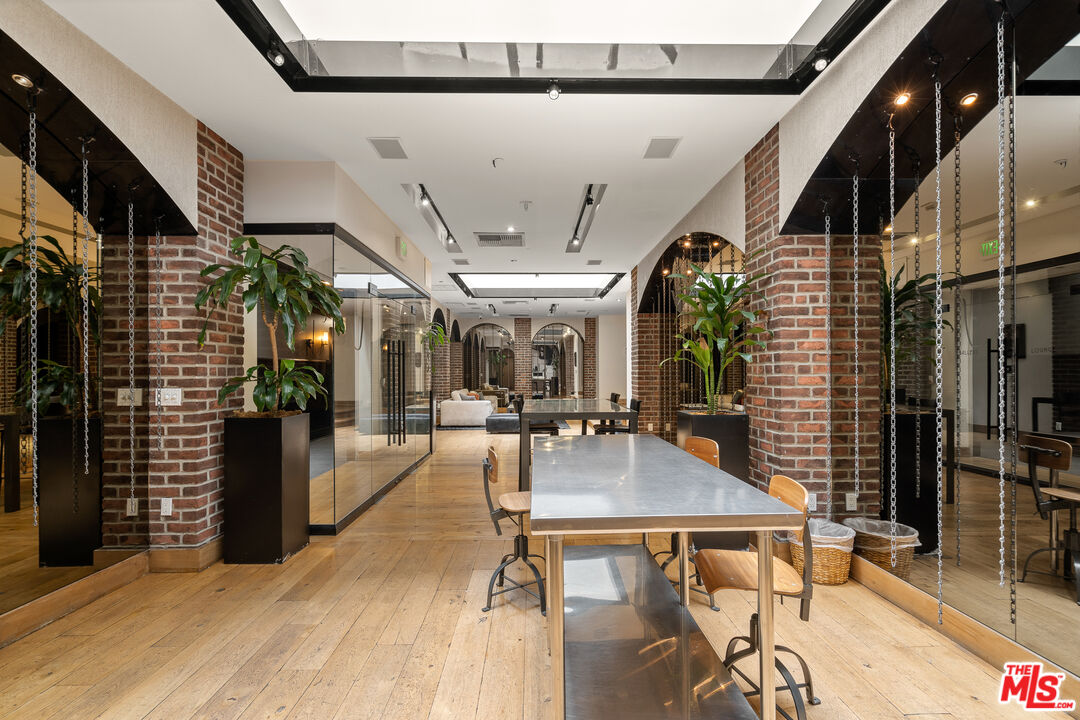 460 South Spring Street, Unit 701 Los Angeles, CA 90013 - Photo 26 of 31 a view of a patio with table and chairs potted plants with wooden floor