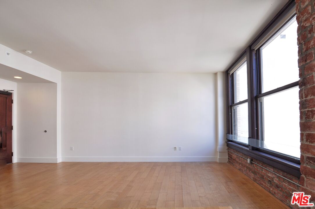 460 South Spring Street, Unit 701 Los Angeles, CA 90013 - Photo 6 of 31 wooden floor in an empty room with a window