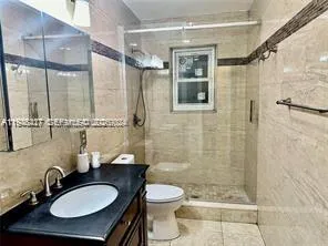 a bathroom with a sink toilet a mirror and shower