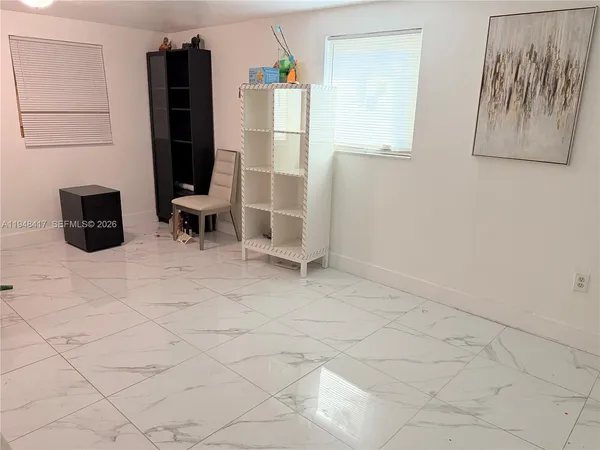 a view of kitchen with furniture and refrigerator