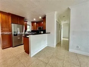a kitchen with stainless steel appliances a refrigerator and a stove