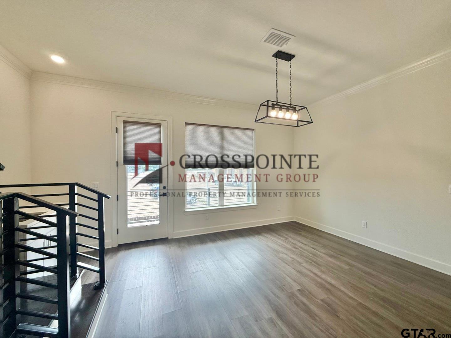 548 West Erwin Street Tyler, TX 75702 - Photo 12 of 27 a view of an empty room with window and wooden floor