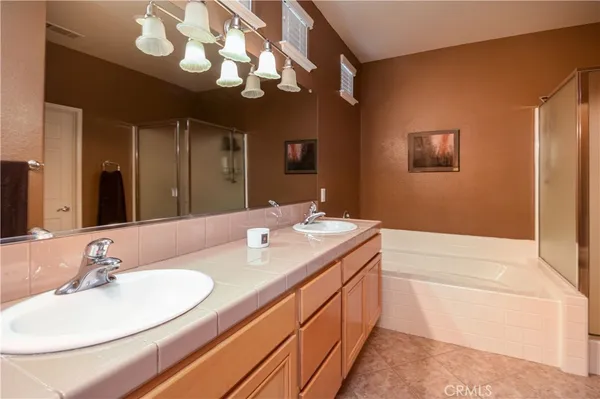 a bathroom with a sink a large mirror and a bathtub