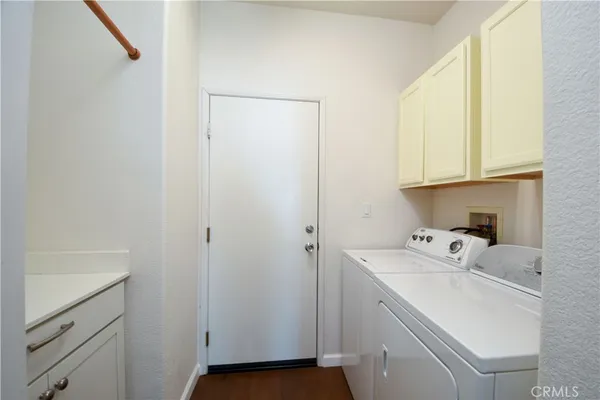 a utility room with sink dryer and washer