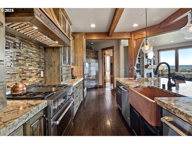 a kitchen with stainless steel appliances granite countertop a sink stove and cabinets