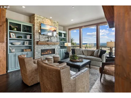 a living room with furniture a rug and a large window