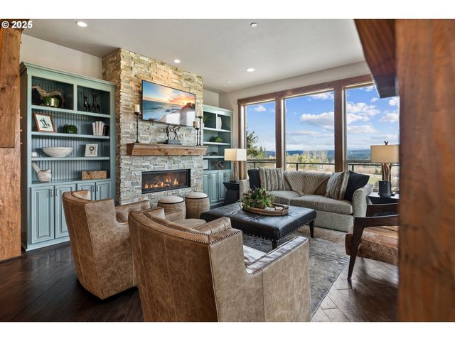 a living room with furniture a rug and a large window