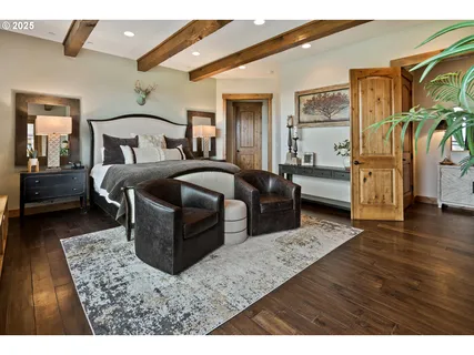 a bedroom with bed and wooden floor