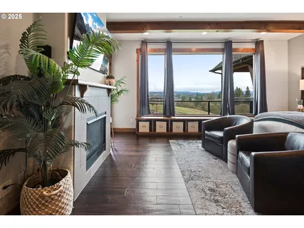 a living room with furniture floor to ceiling window and a potted plant
