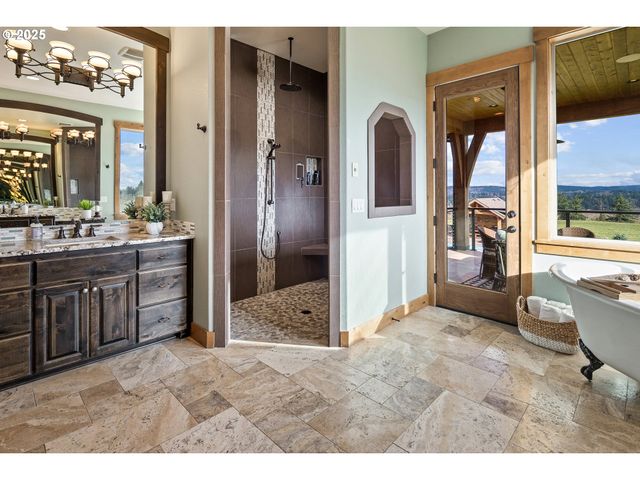 a living room with stainless steel appliances kitchen island granite countertop furniture and a large window