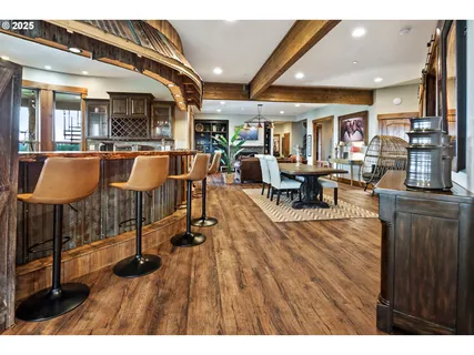 a living room with furniture a wooden floor and a fireplace