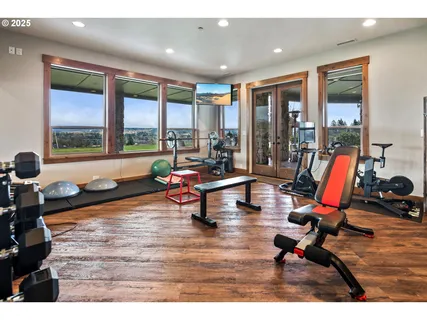 a living room with furniture and floor to ceiling window