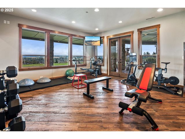 a living room with furniture and floor to ceiling window