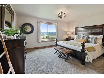 a bedroom with a bed a chandelier and a window