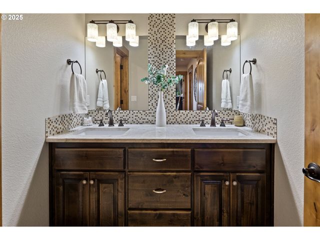 a bathroom with a sink double vanity and a mirror