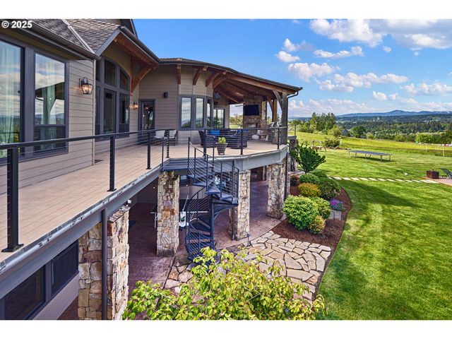 a view of a house with a yard balcony and furniture