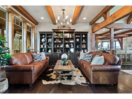 a living room with furniture a chandelier and a large window